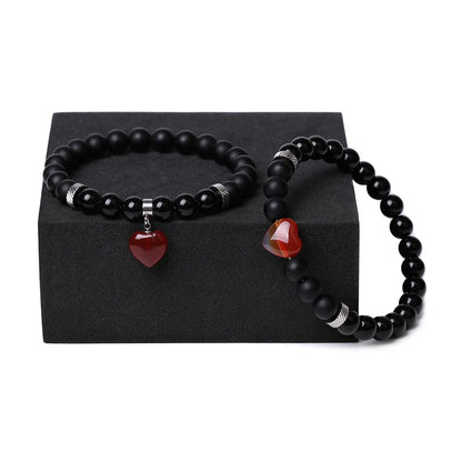 Matching couple bracelets with polished natural stone heart pendants in geometric style