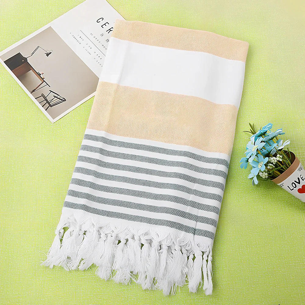 Striped Turkish beach towel showing blue and white pattern, measuring 100cm by 180cm