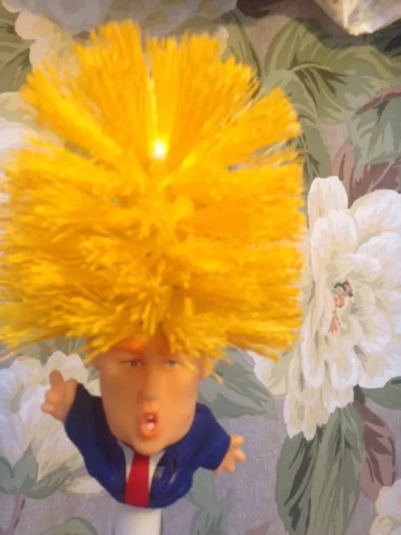 Yellow Donald Trump novelty toilet brush with hanging slot in handle