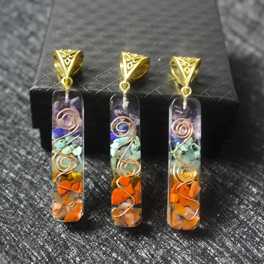A stylish 7-chakra crystal pendant featuring a unique geometric design and natural stone patterns
