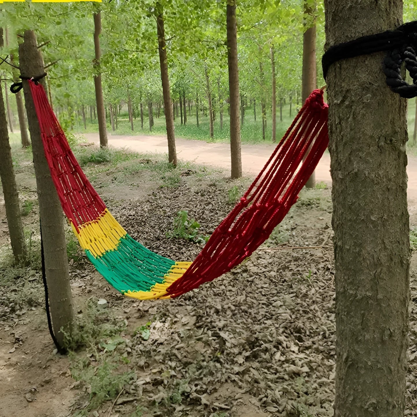 Outdoor nylon rope mesh hammock with tying strap shown in use