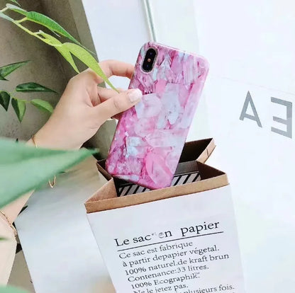 Colourful stone pattern soft back phone case for iPhone on a table.