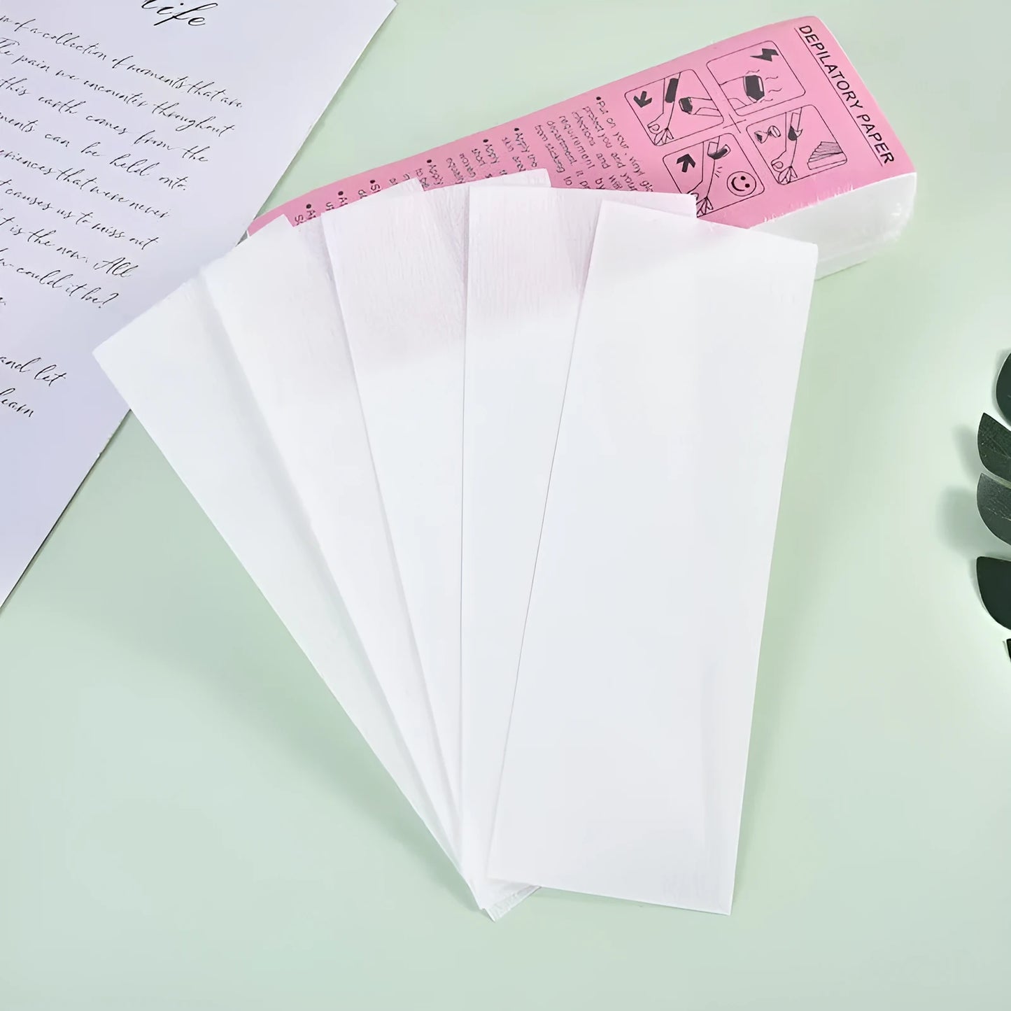 A pack of non-woven fabric hair removal wax paper auxiliary strips.