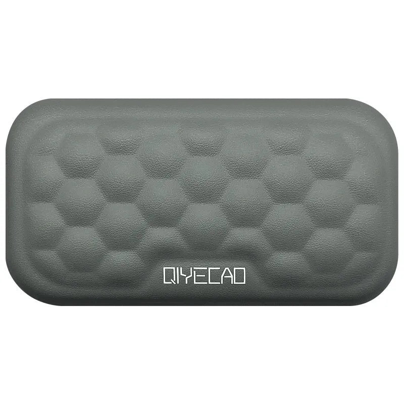 Black and grey memory foam mouse wrist rests with cloth and leather-style covers on a desk.