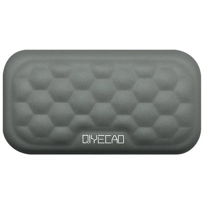 Black and grey memory foam mouse wrist rests with cloth and leather-style covers on a desk.