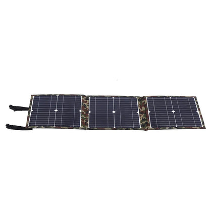 Black foldable portable solar panel unfolded showing solar cells, with included car charger and USB adapter.