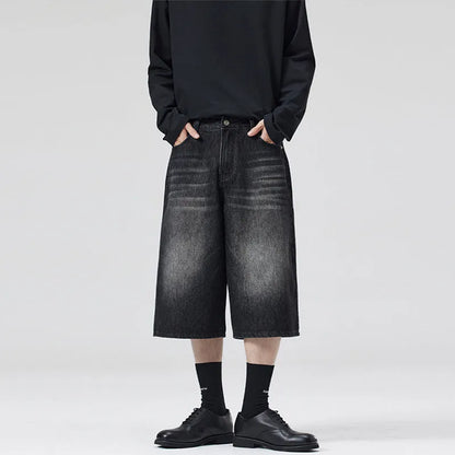 Men's loose straight denim shorts in light blue with cropped length ending above ankle, straight-leg cut