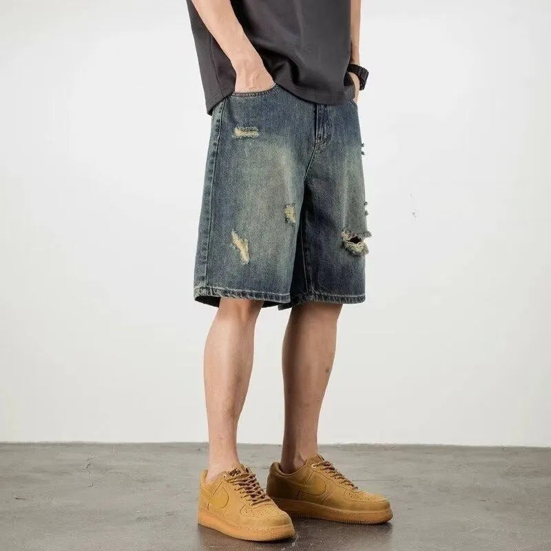 Men's blue distressed denim shorts with loose hole detailing and straight leg cut