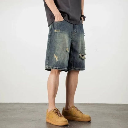 Men's blue distressed denim shorts with loose hole detailing and straight leg cut