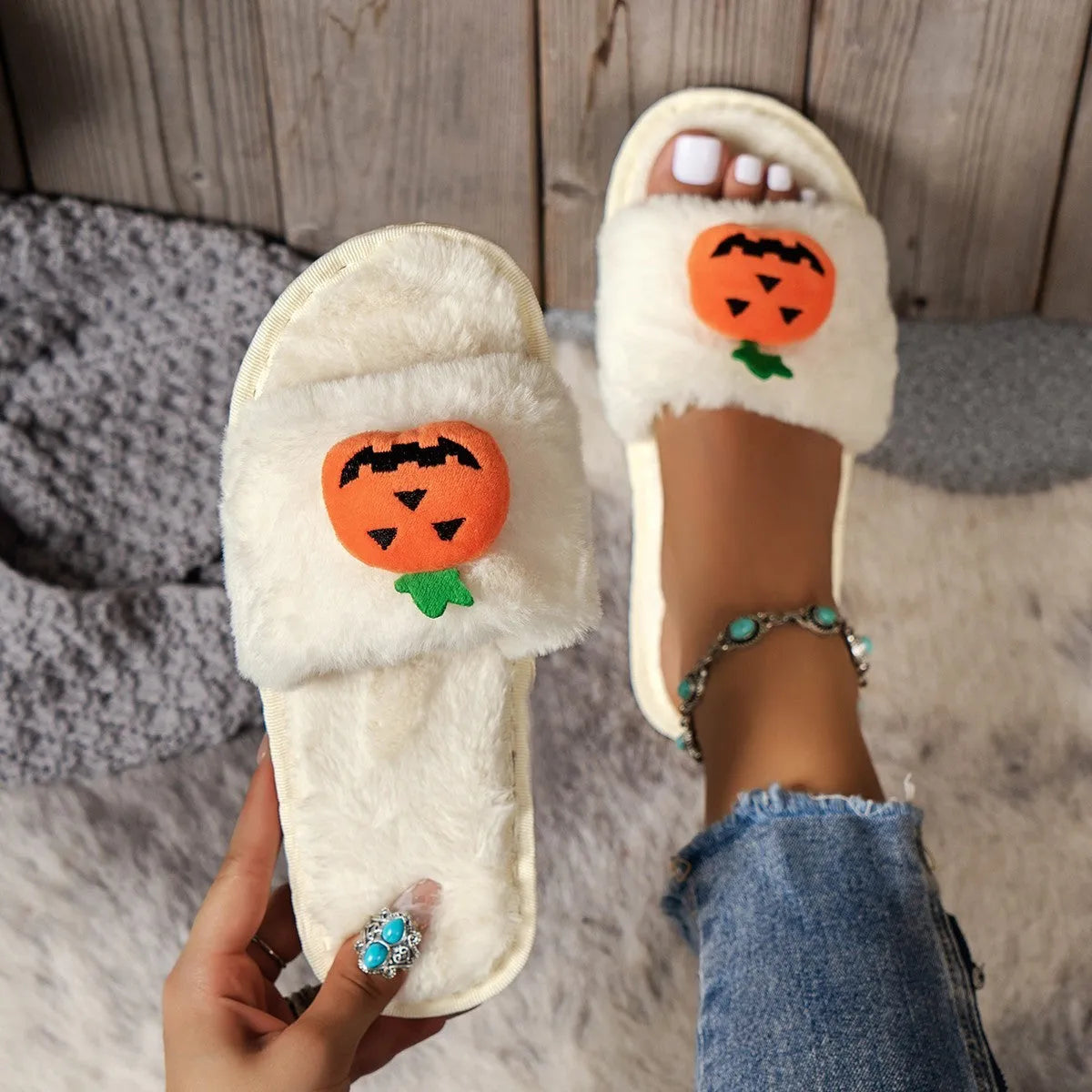 Yellow Halloween pumpkin plush open-toe slippers with synthetic fur and a light grey PVC anti-slip sole.