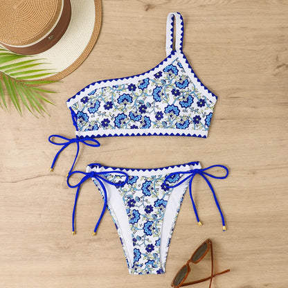 Blue one-shoulder floral bikini set on a mannequin, showing front and back views.