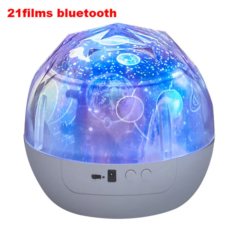 Compact white starry sky projector lamp with Bluetooth speaker projecting constellation images on a blue wall.