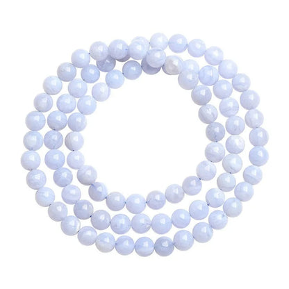 Blue agate bracelet with 6-6.8mm beads in multi-circle pattern and Ruyi elements on a wrist.