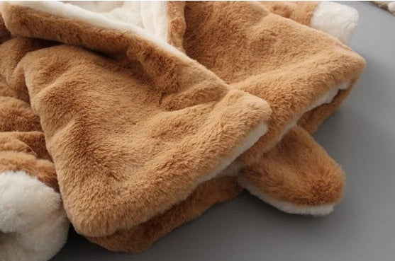 Baby wearing pink cotton coat with velvet accents, showing flocking fabric texture and cotton filling insulation