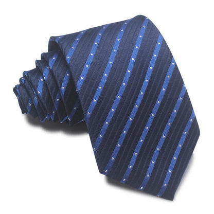 Close-up of a red and black striped jacquard weave tie with an arrow tip, showing texture.