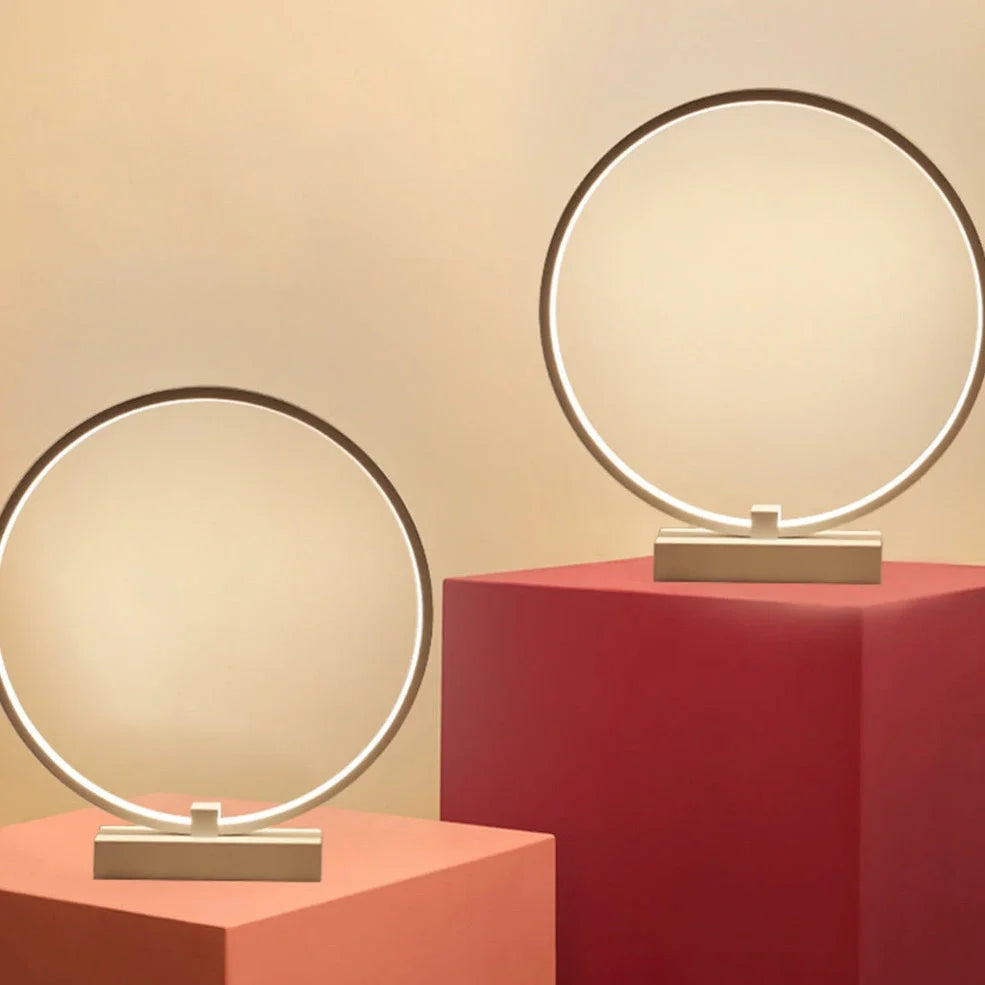 White circular LED bedside lamp with 25cm diameter on iron base showing warm white illumination