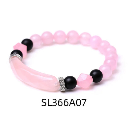 Handmade diamond-shaped cut black agate bracelet with fan-shaped details on a wrist.