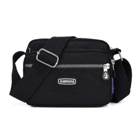 Compact nylon messenger bag in various colors with multiple compartments