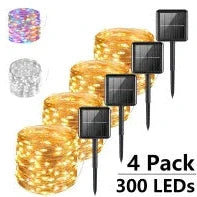 Solar-powered LED string lights arranged in garden with solar panel charging in sunlight