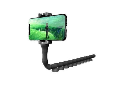 Black flexible gooseneck phone holder with suction cup mounted on a desk, holding a mobile phone at an angle.