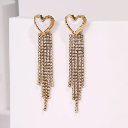 Gold-coloured women's earrings with a love heart shape, star details and dangling diamond-style tassels on a white background.
