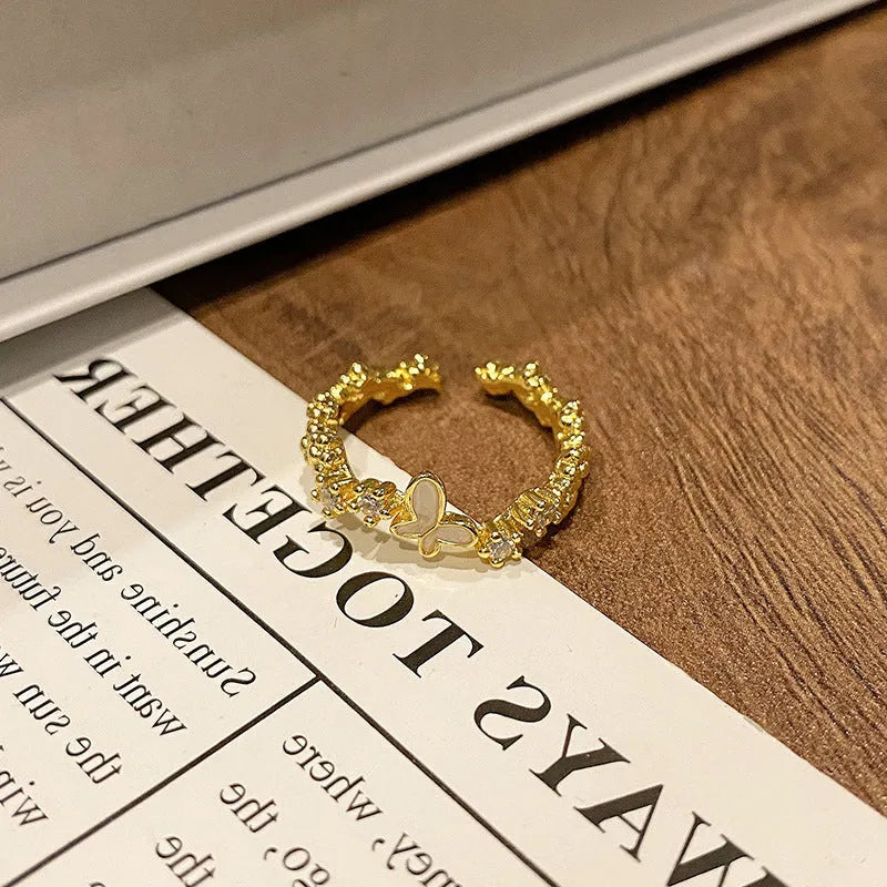 Copper women's ring with Chinese butterfly design and adjustable open loop.