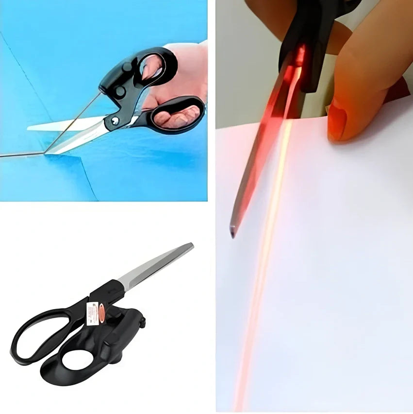 Black laser-guided scissors with red beam cutting straight line on wrapping paper