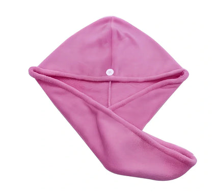 Pink microfiber hair drying towel measuring 25x65cm with button fastening shown wrapped around hair