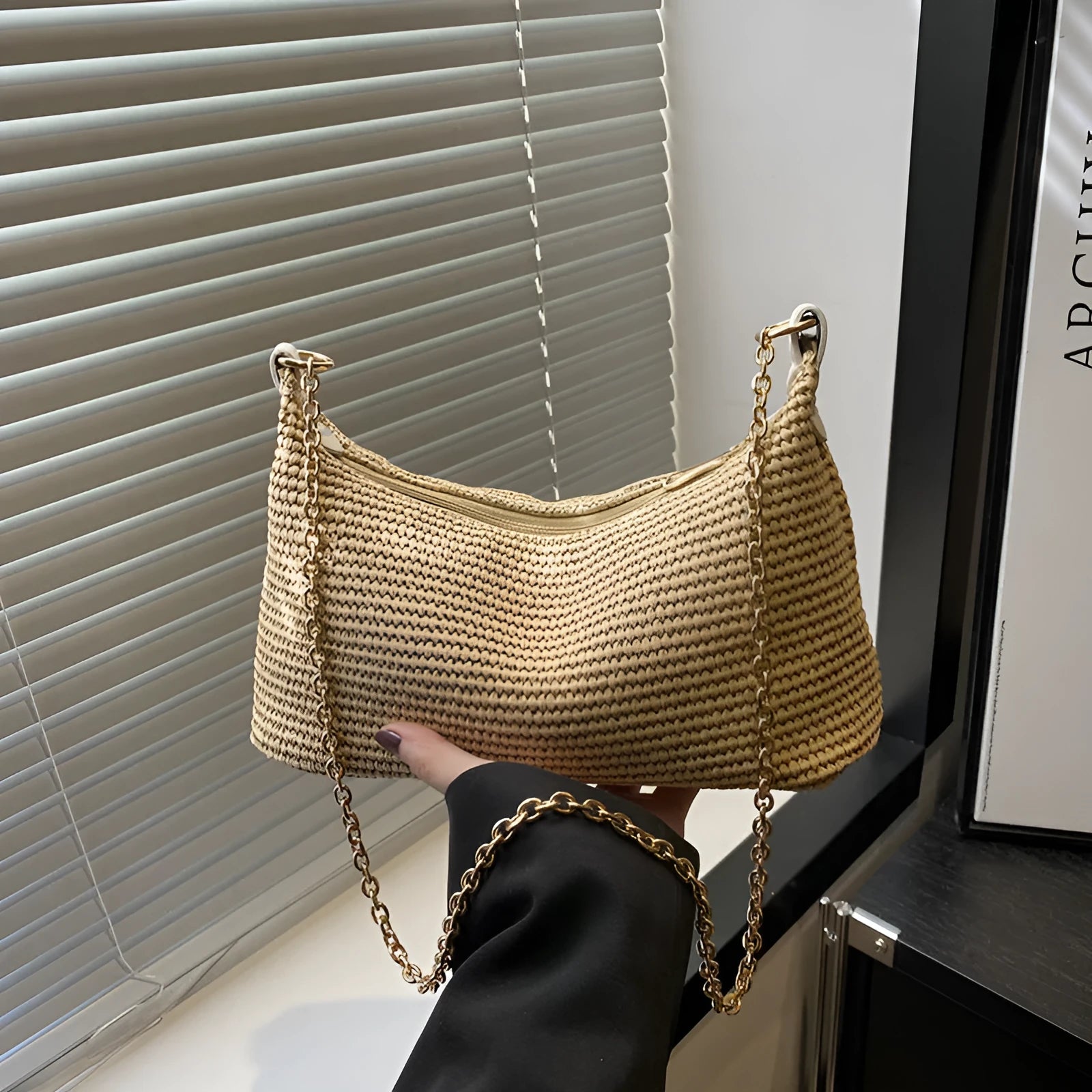 Woven straw shoulder tote bag in a horizontal square shape with a sandwich pocket.