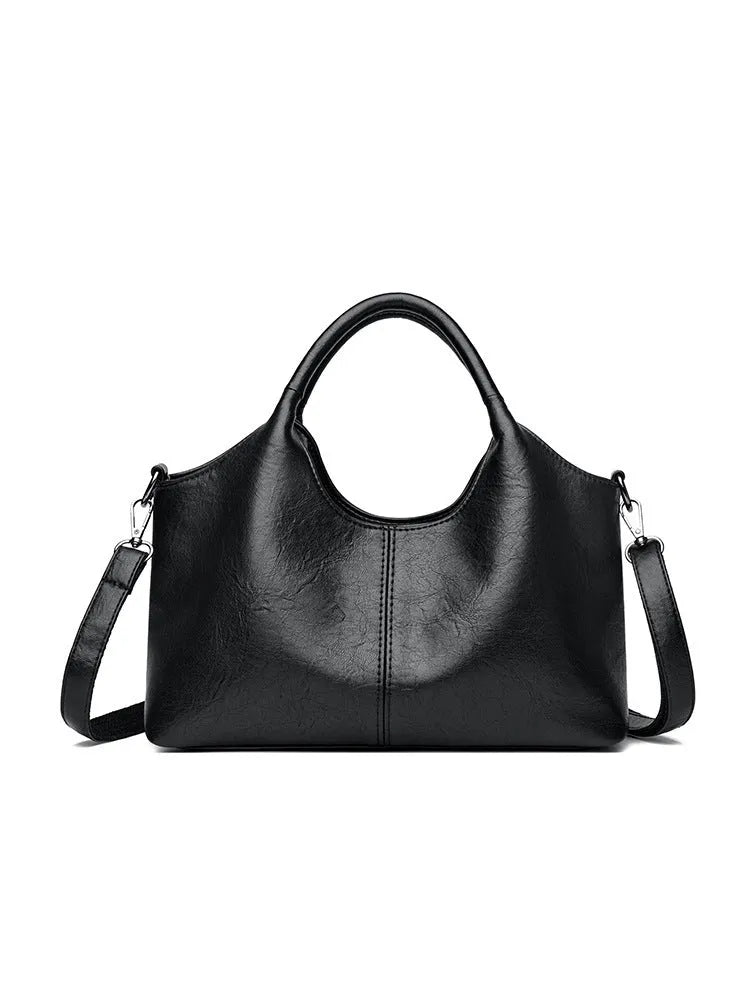 Soft genuine leather women's crossbody bag in beige with large capacity and adjustable strap.