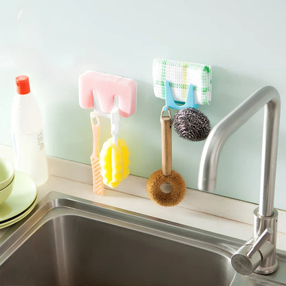 Blue plastic kitchen organiser mounted inside cabinet door holding spatula and spoon