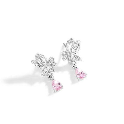 Butterfly shaped silver stud earrings with crystal details on white background