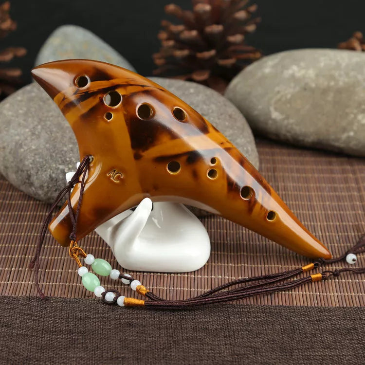 Ceramic 12-hole smoldering ocarina in alto C pitch with nest-inspired design