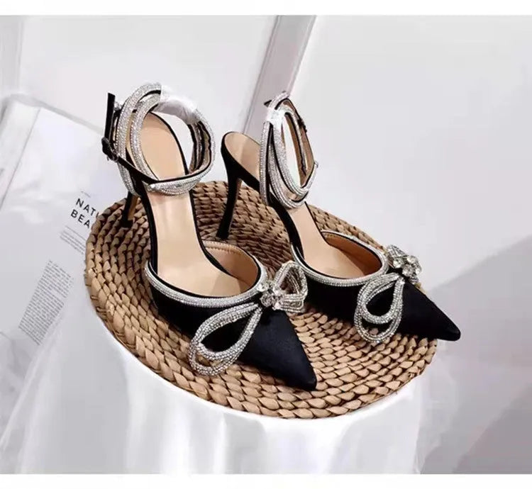 Women's black French style stiletto heel sandals with a silk back bandage and silver buckle closure.