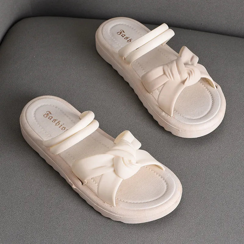 Women's black PVC sandals with thick soft back, floral detail, and injection moulded sole
