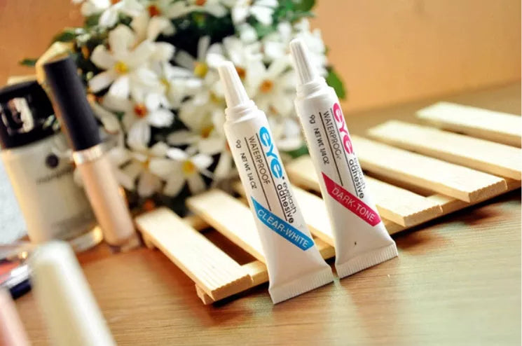 Professional false eyelash glue in black and white for natural, lasting eye makeup