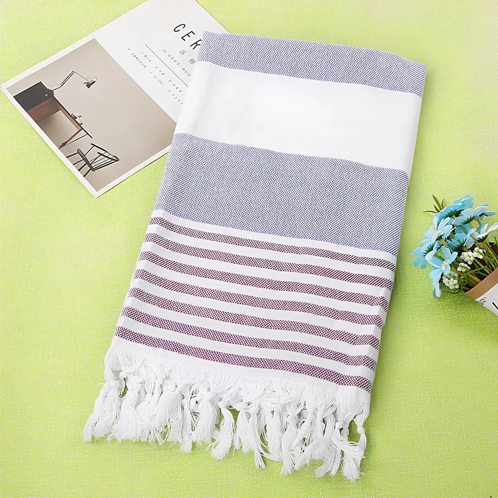 Striped Turkish beach towel showing blue and white pattern, measuring 100cm by 180cm