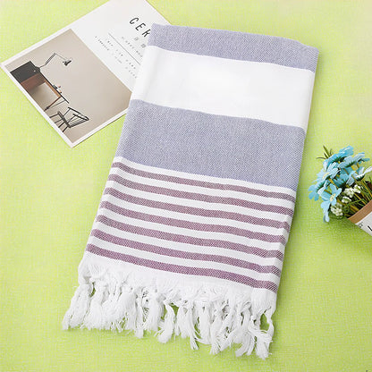 Striped Turkish beach towel showing blue and white pattern, measuring 100cm by 180cm