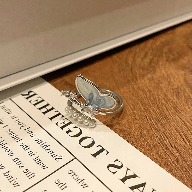 Copper women's ring with Chinese butterfly design and adjustable open loop.