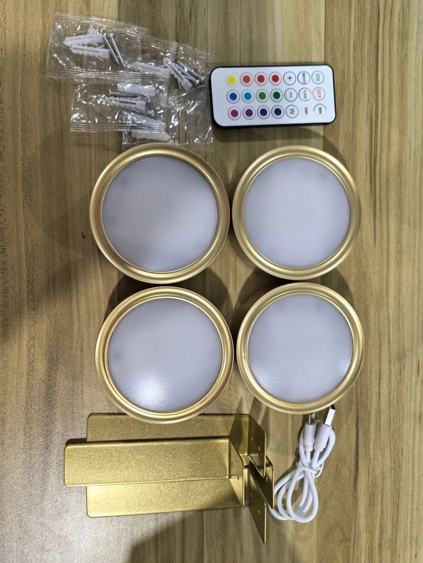 Black magnetic LED painting lamp with remote control on a white wall.