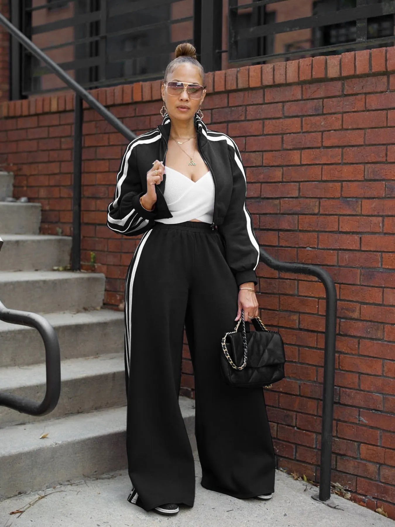 Grey striped streetwear two-piece suit set with zipper detailing on the top and trousers.