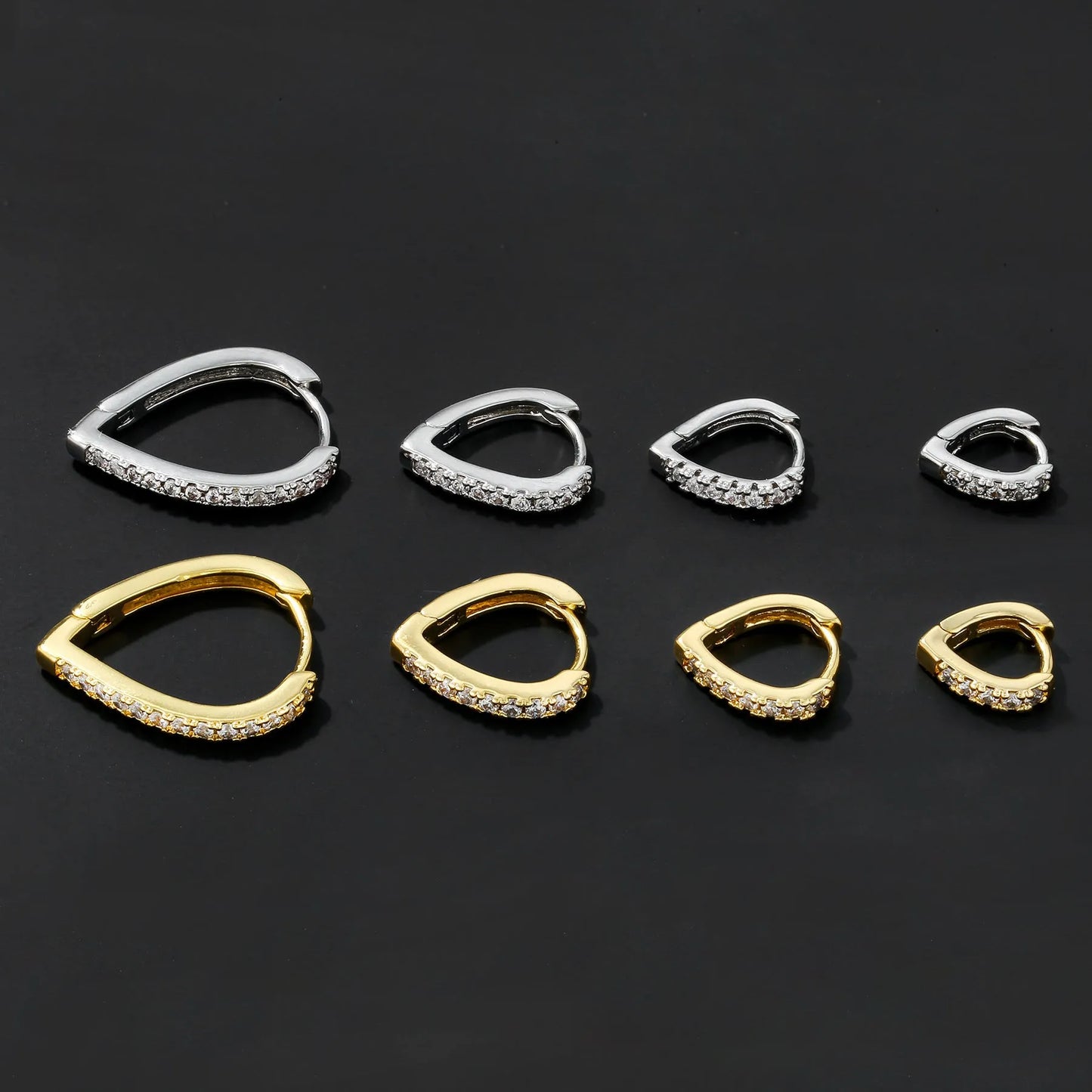 Copper geometric heart ear clip with electroplated finish in gold and white colour options on earlobe