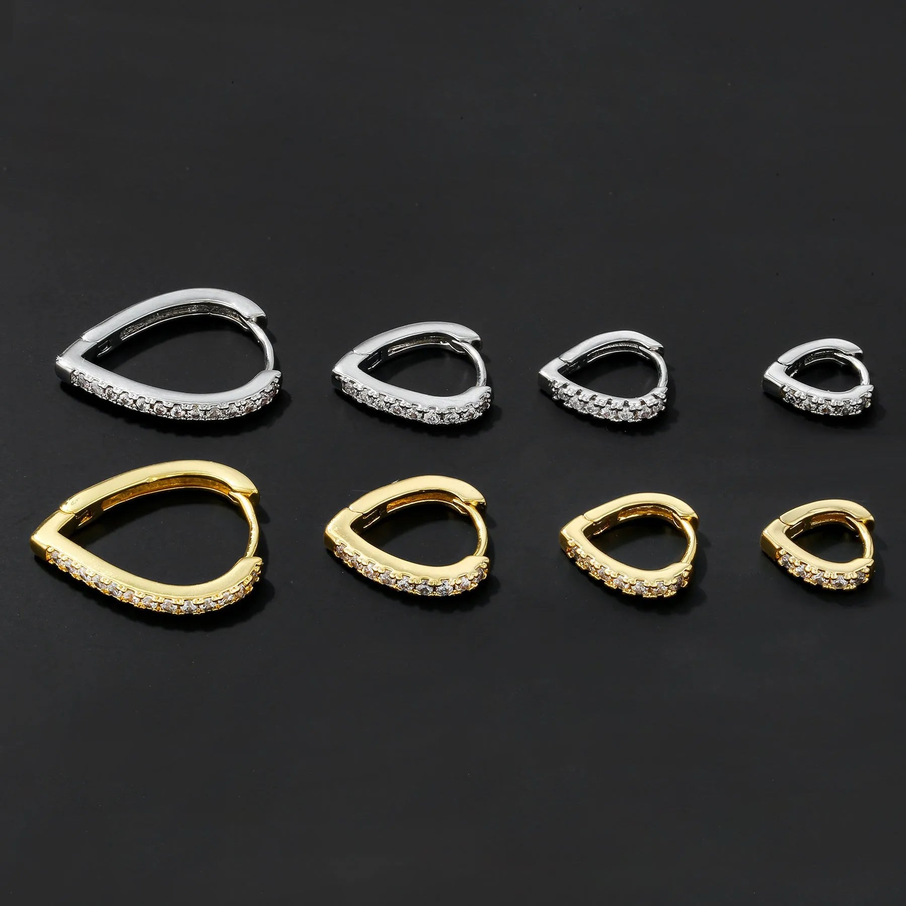 Copper geometric heart ear clip with electroplated finish in gold and white colour options on earlobe