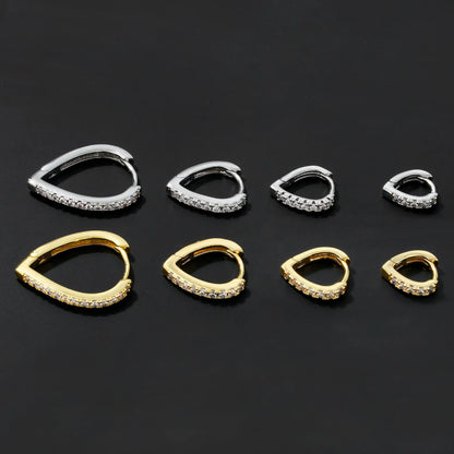 Copper geometric heart ear clip with electroplated finish in gold and white colour options on earlobe