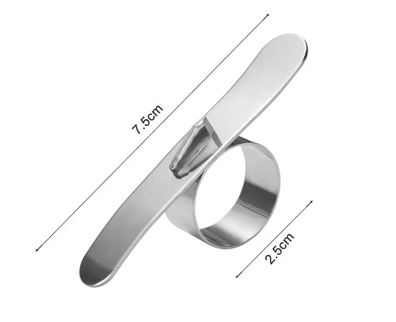 Silver stainless steel citrus fruit peeler with a ring handle on a wooden surface.