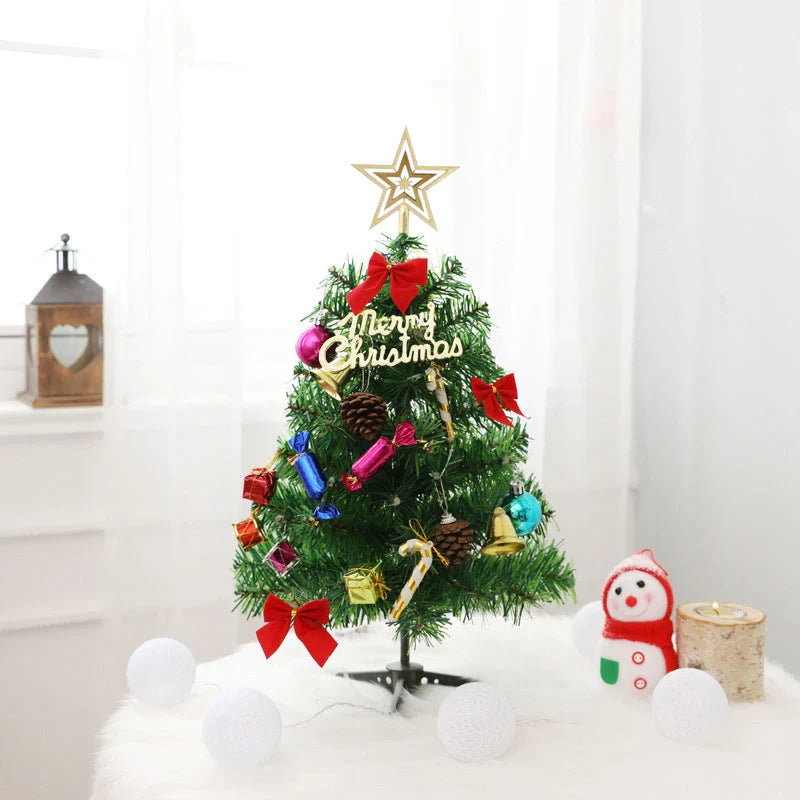 Mini Christmas tree with multi-color LED lights and festive accessories on a desktop