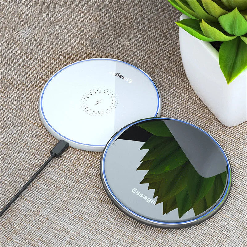 Black wireless charger on table with phone charging, showing blue LED light and anti-slip surface