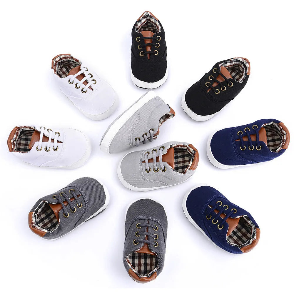 Baby canvas shoes in solid colour with soft bottom and front strap, sizes 11cm to 13cm
