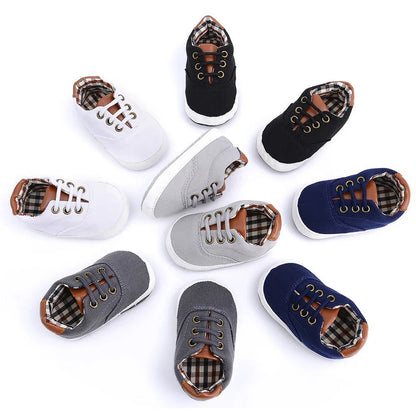 Baby canvas shoes in solid colour with soft bottom and front strap, sizes 11cm to 13cm