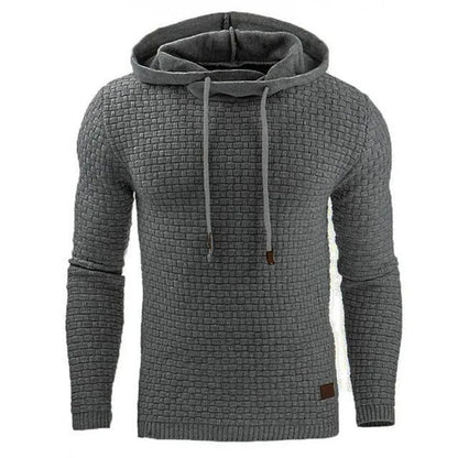Man wearing a cotton-polyester blend hooded sweatshirt in grey, showing the front design and hood.
